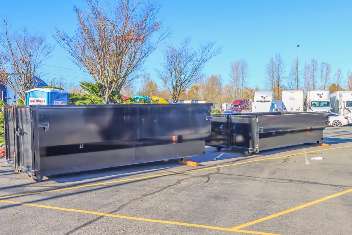 Professional dumpster rental service with roll-off container on residential driveway in Little Elm